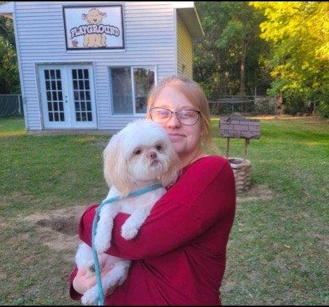 Grace outside by the Happy Tails Playground with a white dog